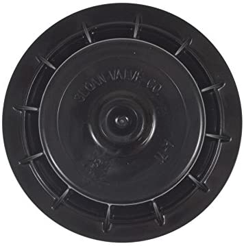 Black circular plastic flush valve cover with centered knob and rectangular mounting tabs around perimeter.