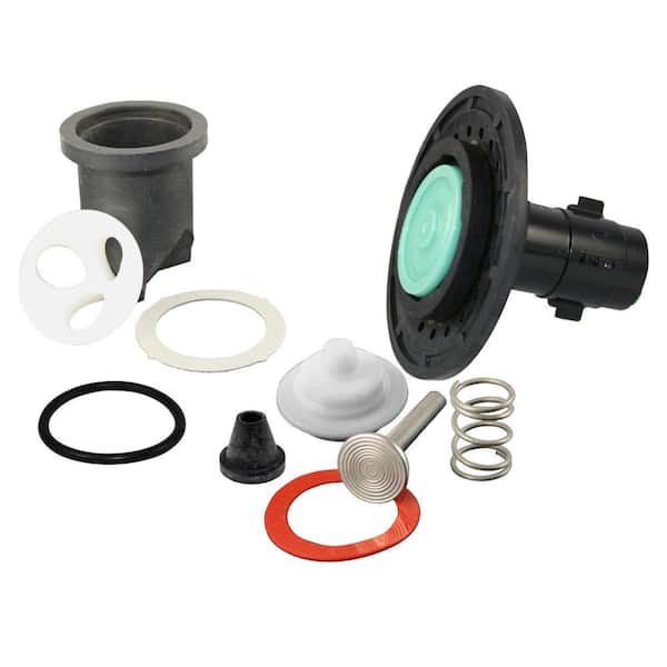 Toilet repair kit components including flush valve, gaskets, springs, and diaphragm assembly.