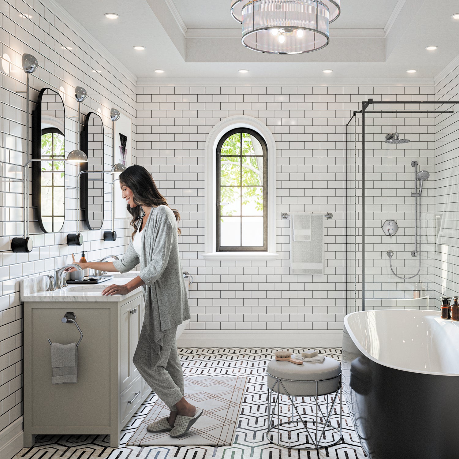 Chrome freestanding tub filler with curved spout and detachable handshower in bathroom setting.
