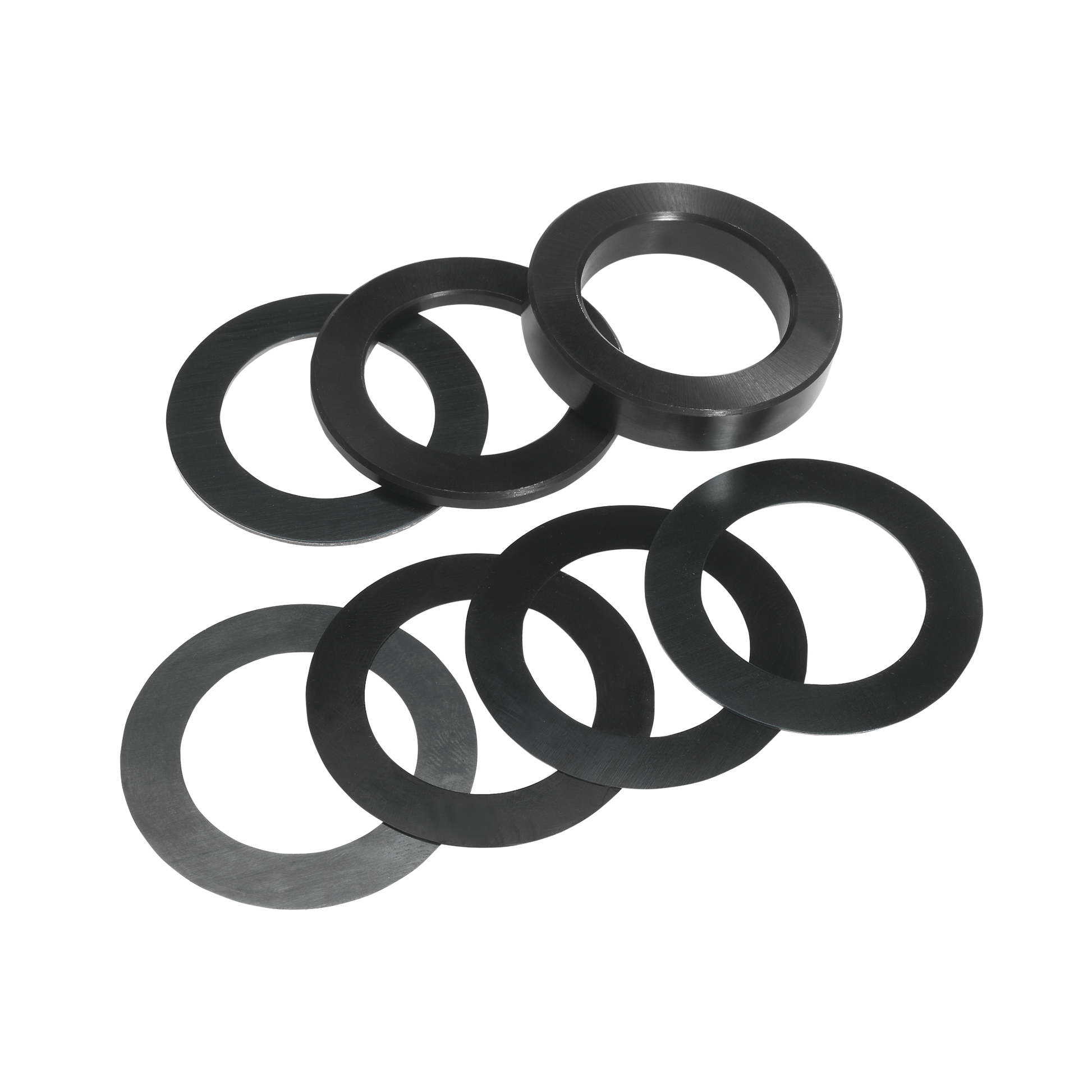Eight black rubber shim rings arranged in two groups on white background.