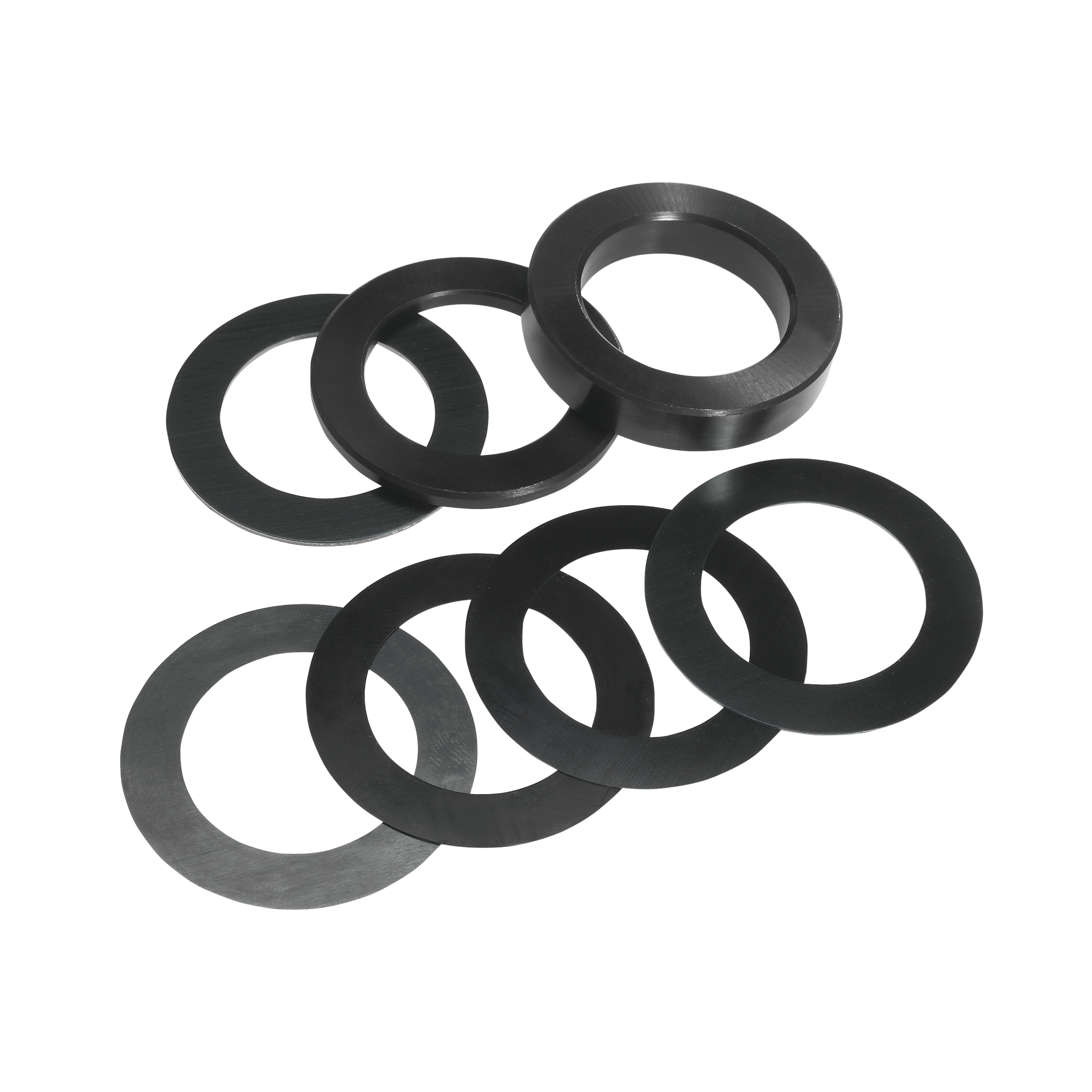 Eight black rubber shim rings arranged in two groups on white background.