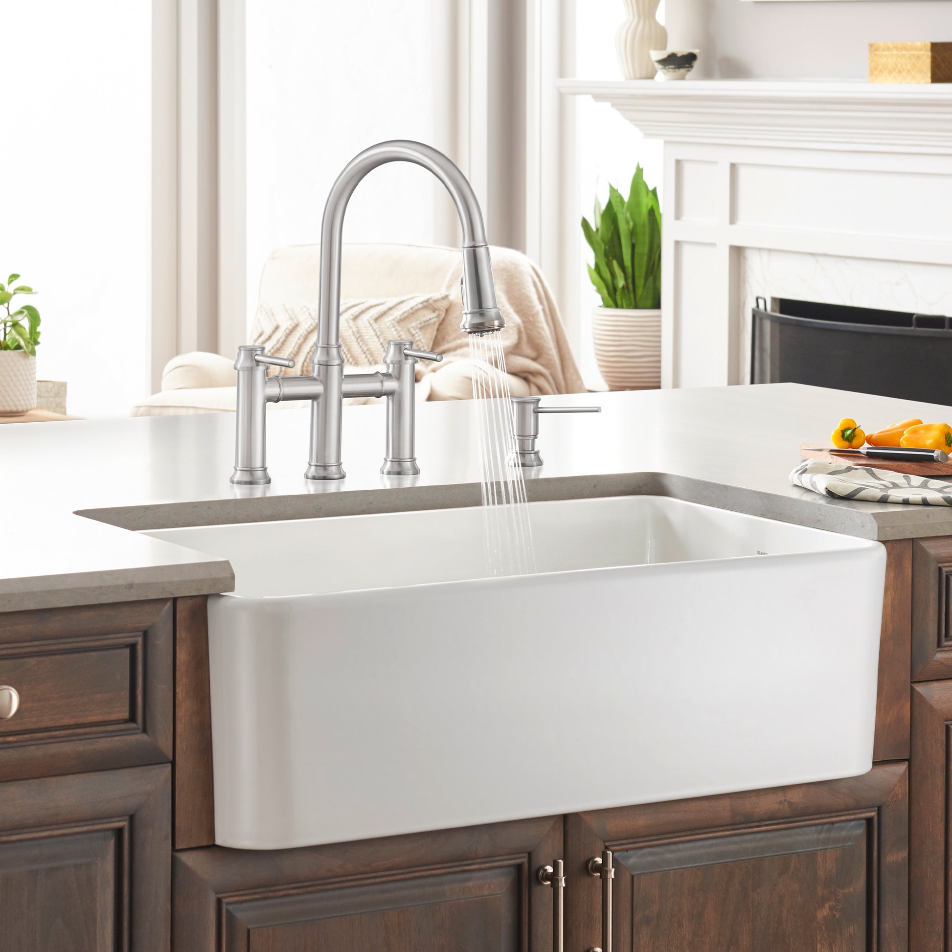 White ceramic farmhouse sink with single basin and curved front apron, installed in wood cabinetry with chrome faucet.