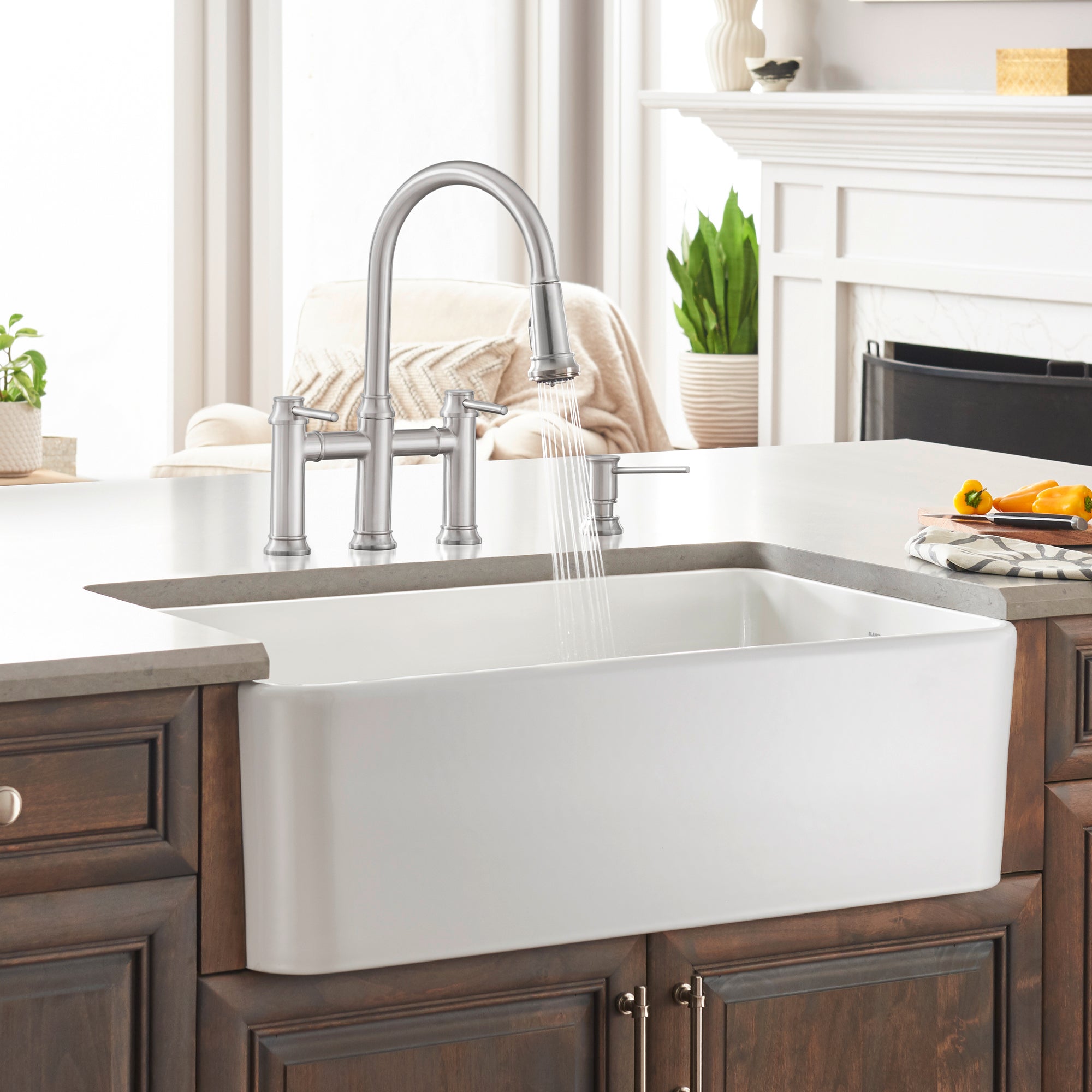 White ceramic farmhouse sink with single basin and curved front apron, installed in wood cabinetry with chrome faucet.