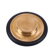 Brushed bronze sink stopper with black rubber rim, viewed from above.