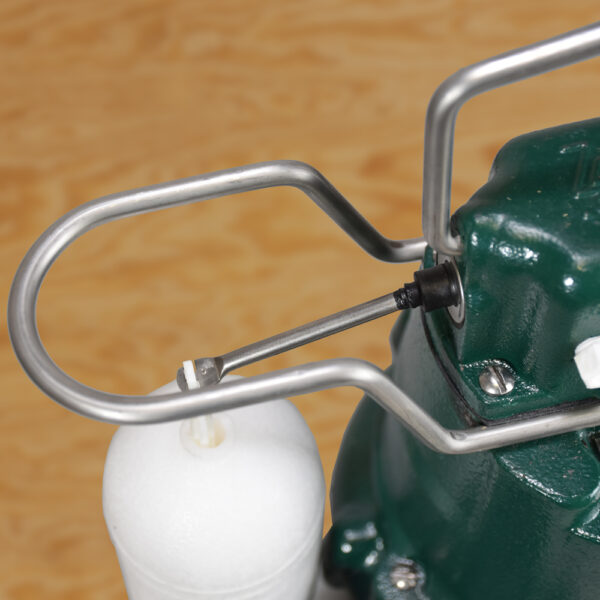 Green and white submersible sump pump with metal carry handle and white float switch on cord.