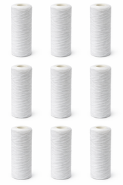 Nine white cylindrical polypropylene string wound sediment filter cartridges with open ends arranged in three rows.