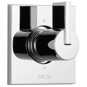 Chrome and black Delta Vero diverter trim with round handle and rectangular escutcheon plate mounted on white background.