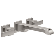 Chrome wall-mount faucet trim with two square handles and curved spout extending to the right.