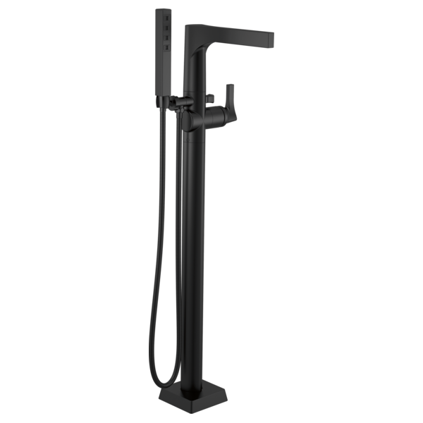 Black floor-mount tub filler with single lever handle, curved spout, and hand shower on hose.