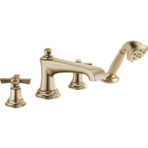 Brass roman tub faucet with cross handles and detachable handshower on white background.
