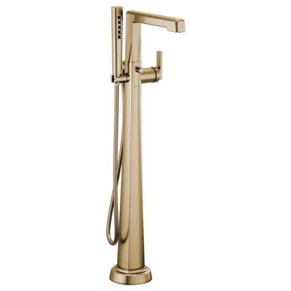 Champagne bronze floor-mount tub filler with single lever handle, curved spout, and detachable handheld showerhead with hose.