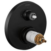 Matte black round thermostatic valve trim with upper white handle and lower brass cartridge outlet, mounted on circular escut