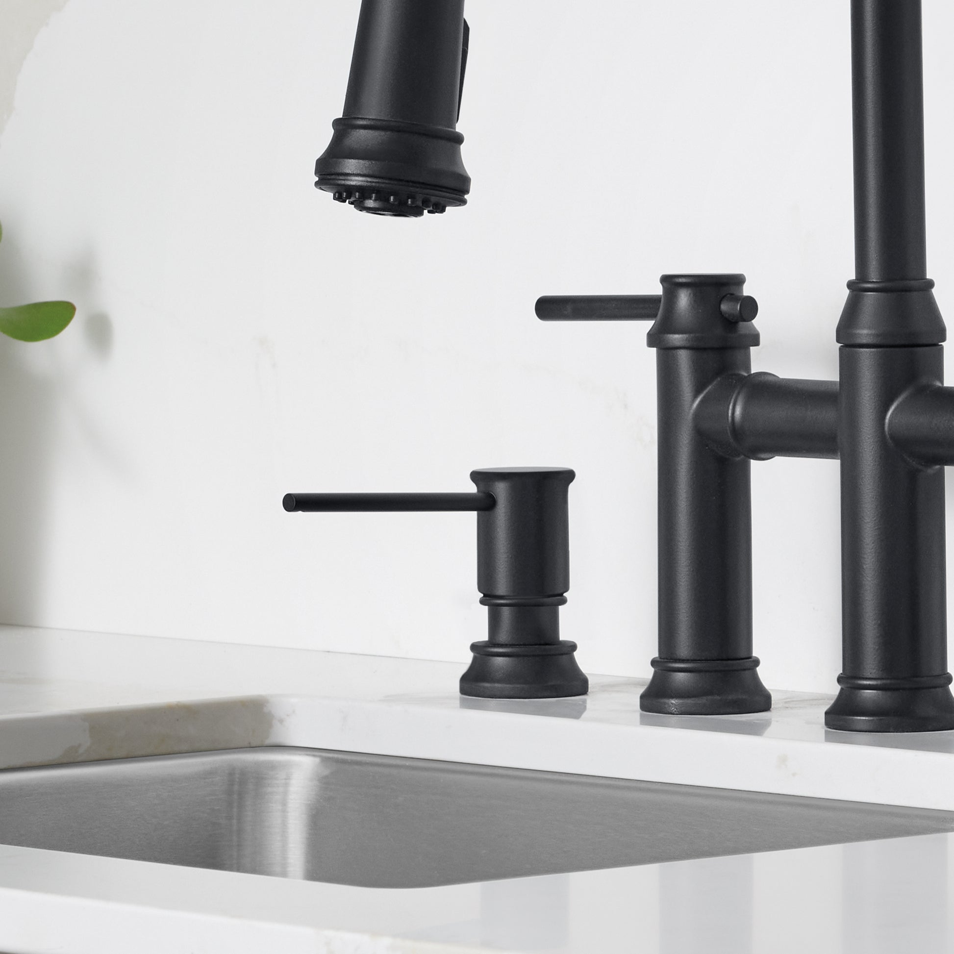 Matte black soap dispenser with cylindrical pump and lever handle mounted on white sink countertop.