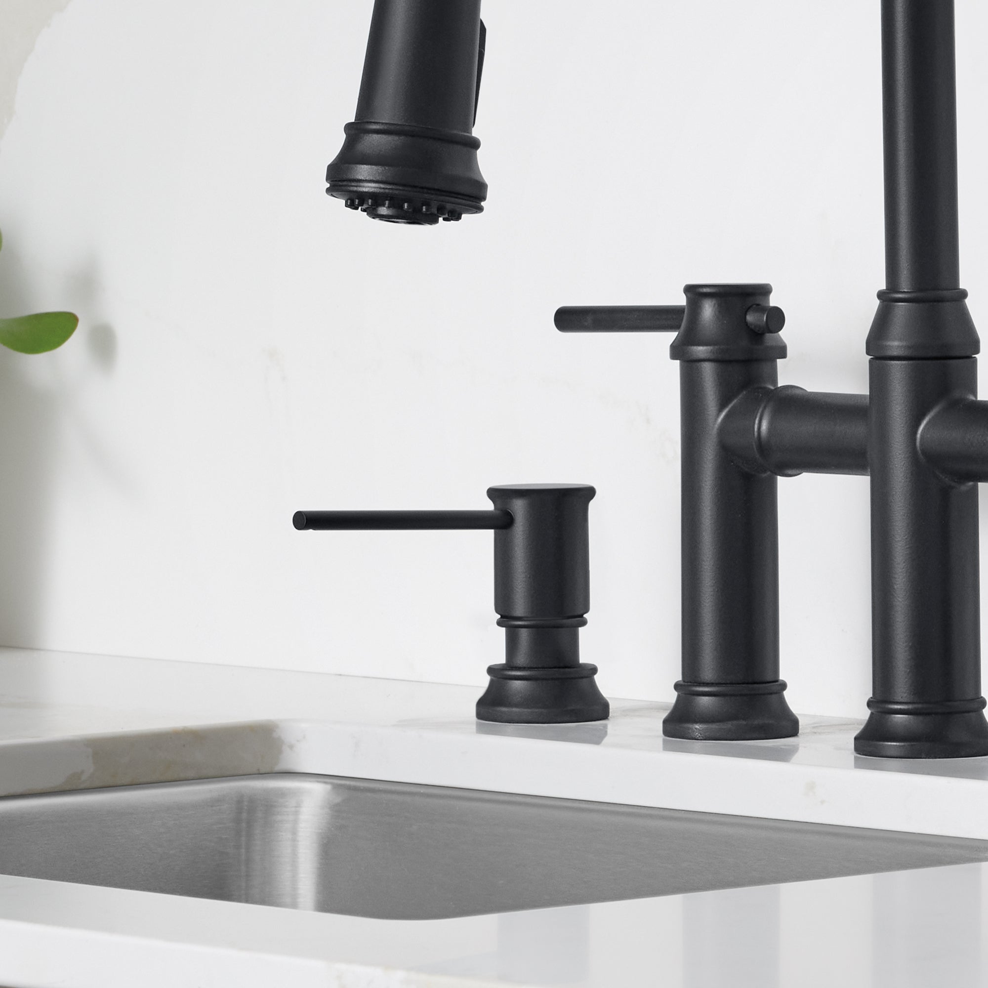 Matte black soap dispenser with cylindrical pump and lever handle mounted on white sink countertop.