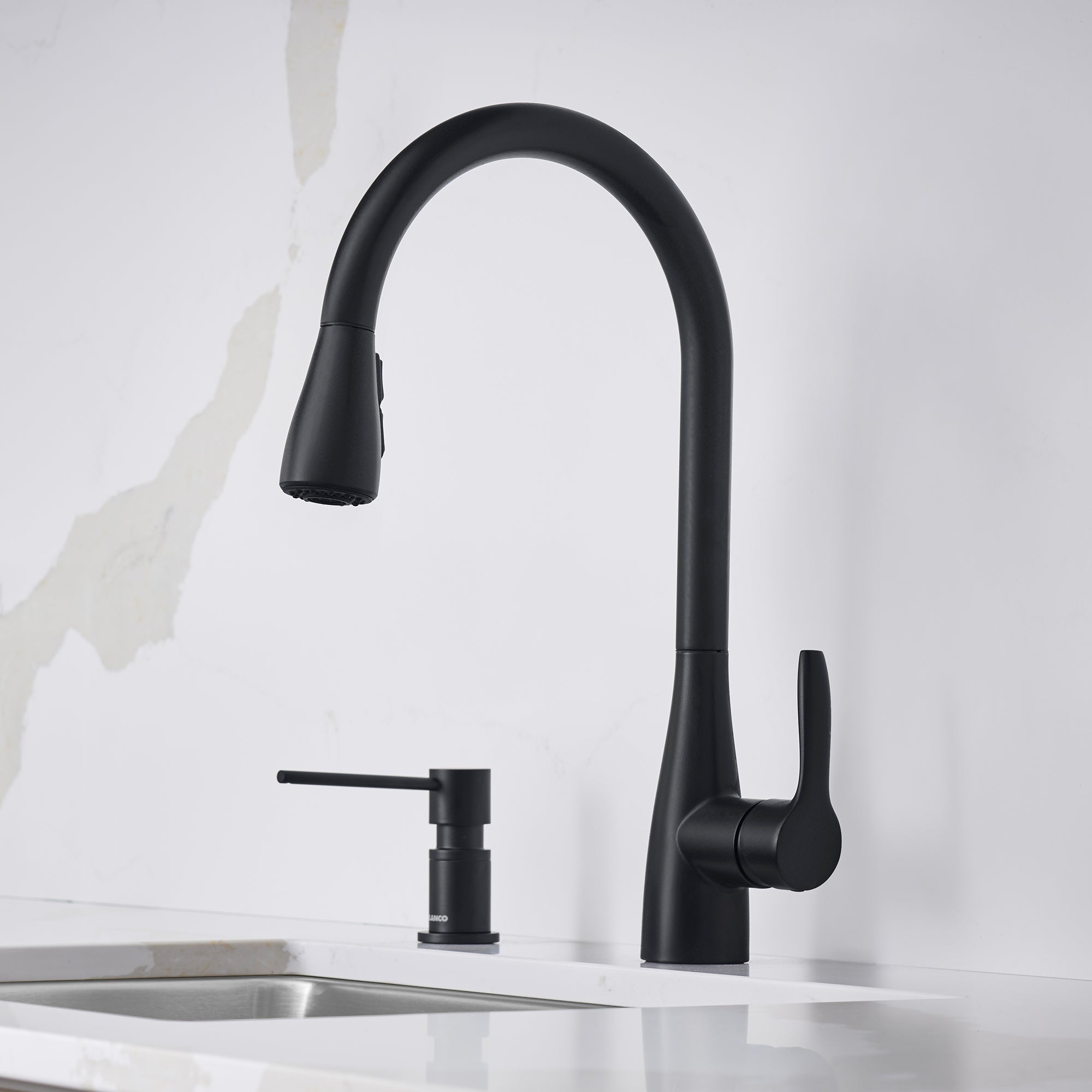 Matte black pull-down kitchen faucet with curved spout, single lever handle, and soap dispenser.