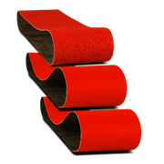 Three red sanding belts with black backing material stacked diagonally against white background.