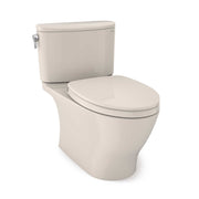 Two-piece elongated toilet in sedona beige with soft-close seat and matching tank with fill valve visible on left side.