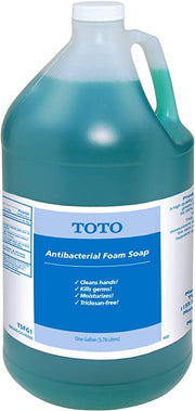 Toto antibacterial foam soap in a clear gallon jug with turquoise liquid and white cap.
