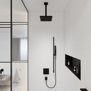 Matte black ceiling-mounted shower extension pipe with square showerhead, installed above wall-mounted control panel in bathr