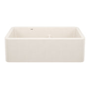 Soft white rectangular apron front sink with low divide basin and rounded corners.