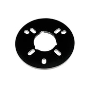 Black circular drain component with central opening and eight mounting slots arranged around the perimeter.