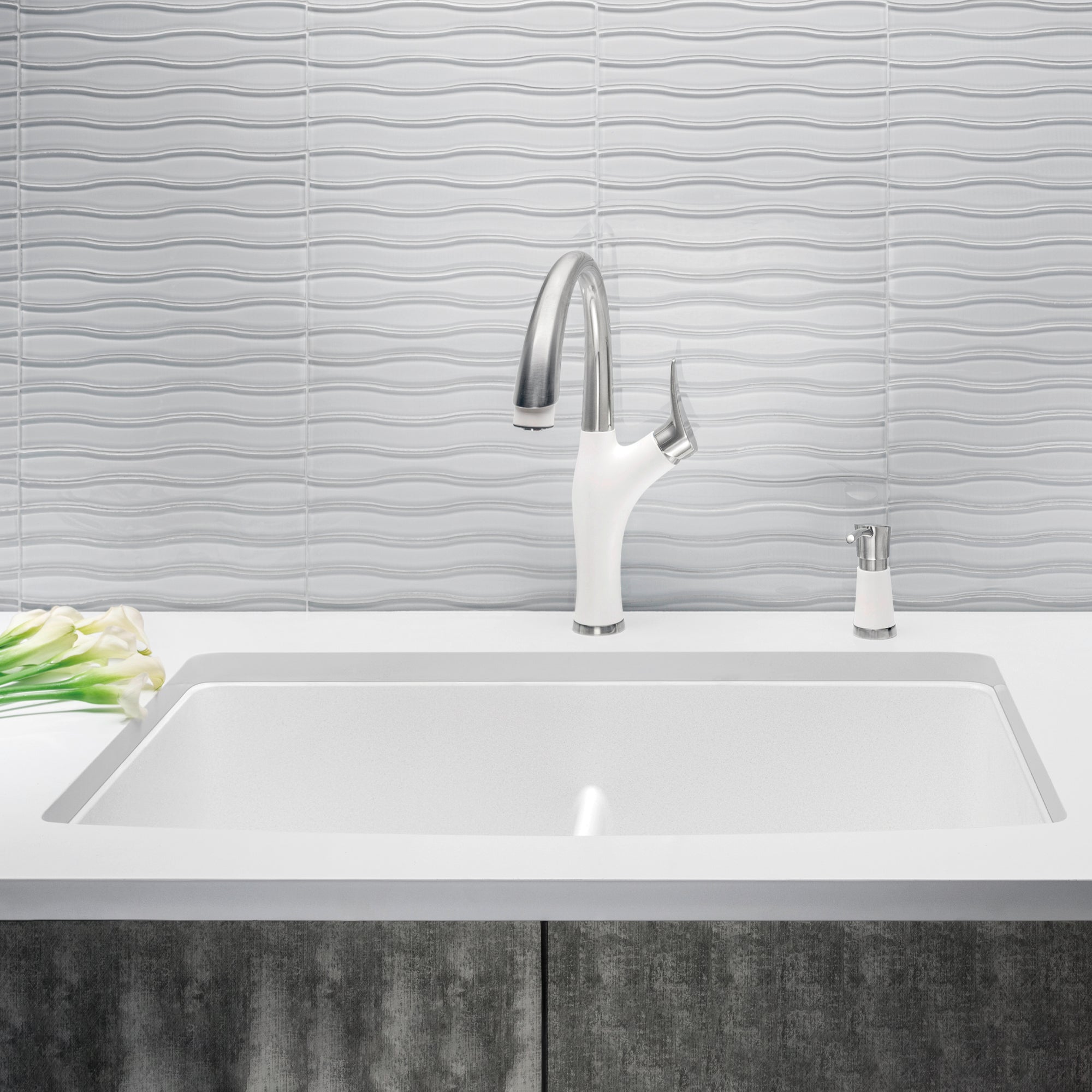 White undermount kitchen sink with equal double bowls and low divider, paired with chrome pull-down faucet and soap dispenser