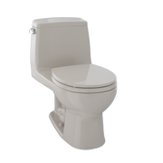 Bone-colored one-piece round toilet with closed soft-close seat and matching tank.