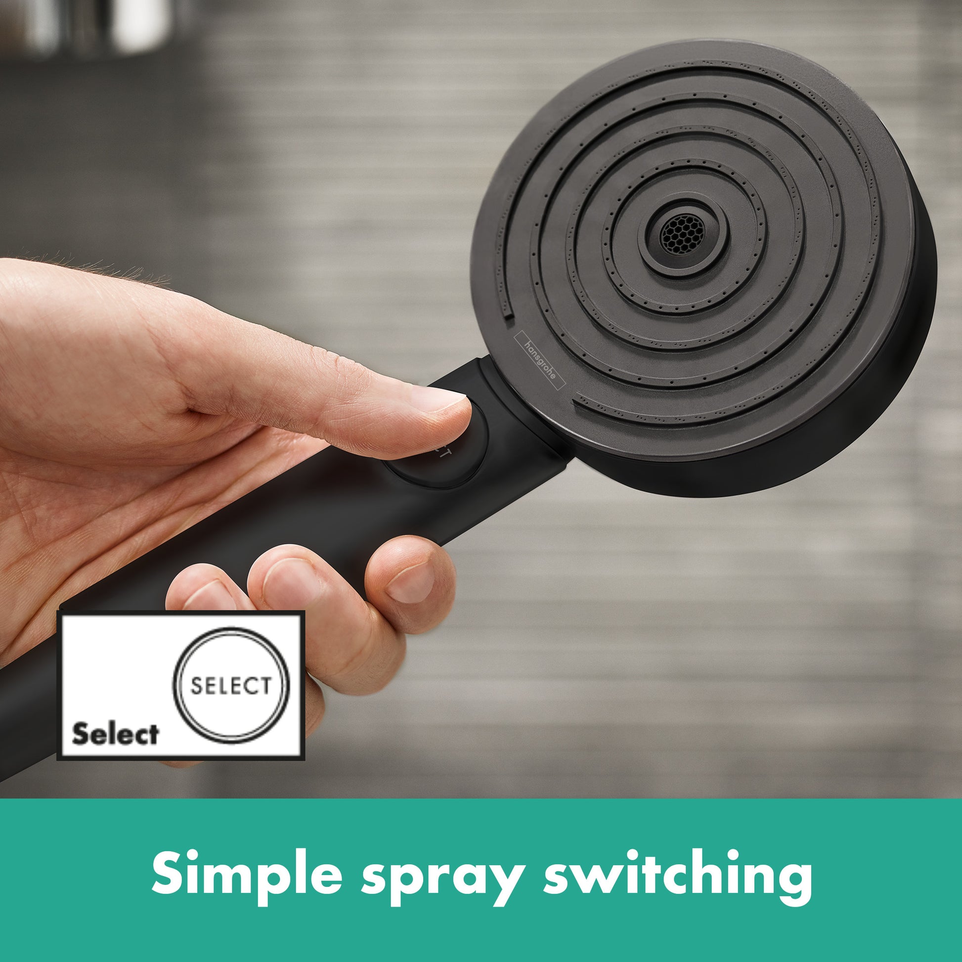 Matte black handheld showerhead with circular concentric spray pattern held in hand, showing grip and spray face.