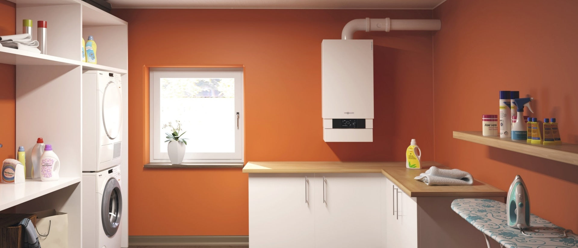 White wall-mounted condensing boiler with digital display installed in orange laundry room above counter.
