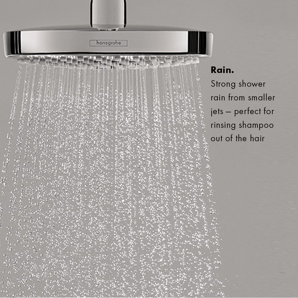 Brushed nickel rectangular shower head with multiple small water jets creating a rain-like spray pattern.
