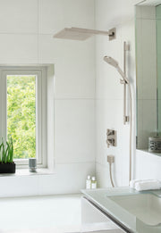 Brushed nickel thermostatic shower system with overhead rainfall head, handheld wand, and wall-mounted controls in bathroom s