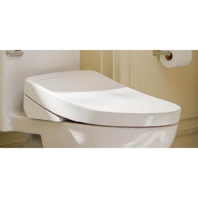 Cotton white round Toto S5 Washlet bidet seat mounted on toilet bowl with closed lid.