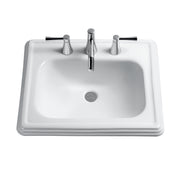 White rectangular bathroom sink with rounded basin and three chrome faucet holes spaced 4 inches apart.