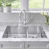 Stainless steel double bowl undermount kitchen sink with faucet, viewed from above.