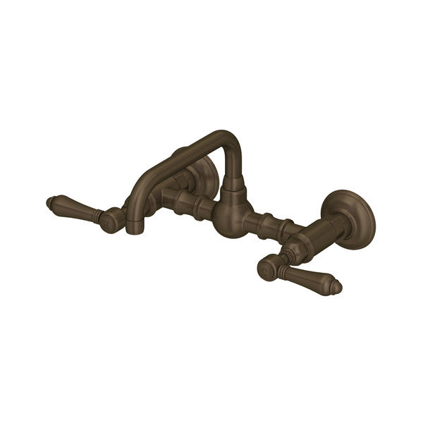 Tuscan brass wall-mount bridge faucet with curved U-shaped spout and dual lever handles.
