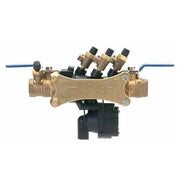 Brass backflow preventer with three black solenoid valves on top, blue inlet and outlet ports, and black actuator assembly be