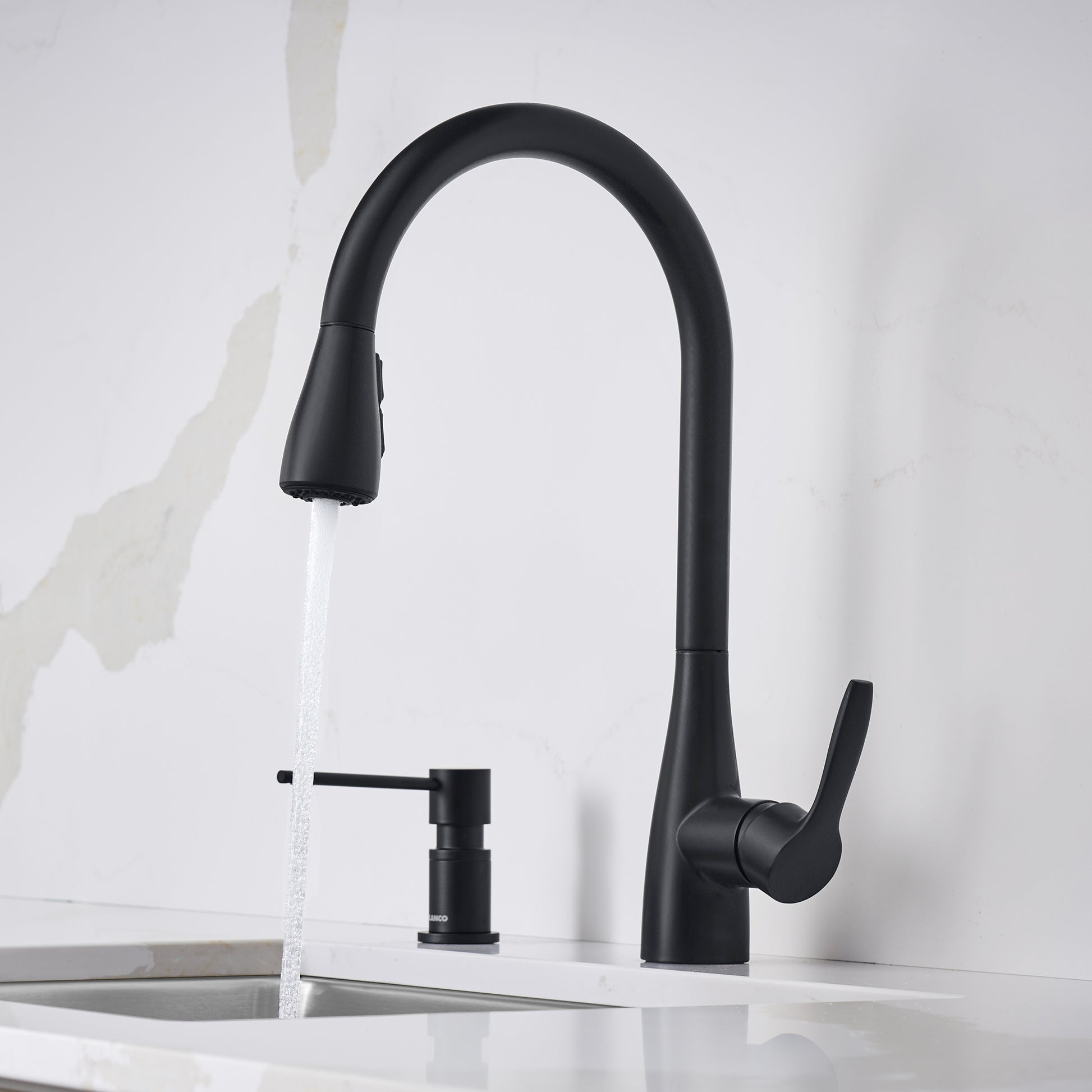 Matte black pull-down kitchen faucet with curved spout, side lever handle, and soap dispenser mounted on white sink.