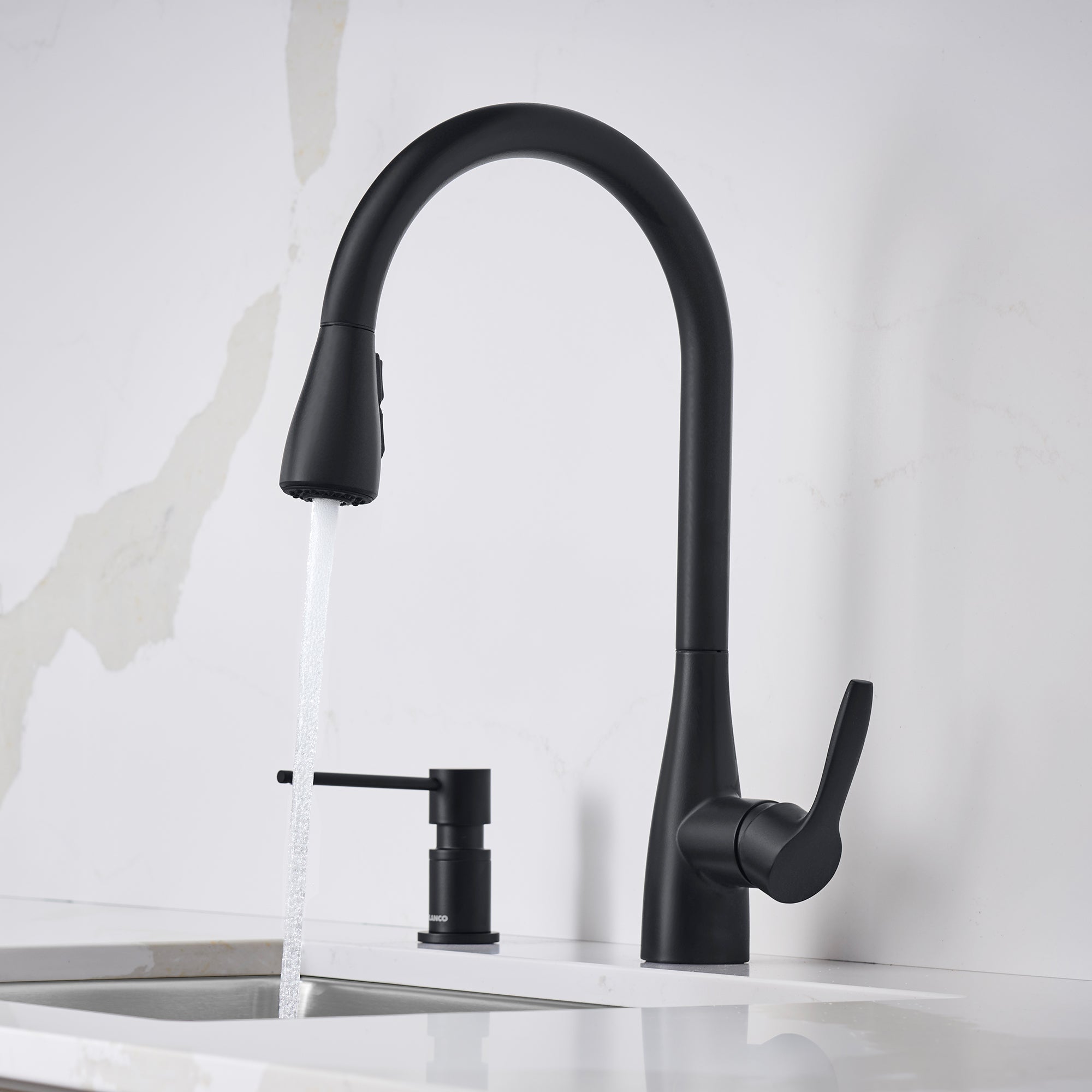Matte black pull-down kitchen faucet with curved spout, side lever handle, and soap dispenser mounted on white sink.