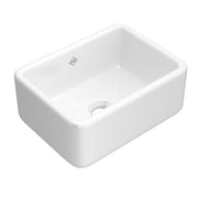 White fireclay apron front kitchen sink with single bowl and rounded corners.