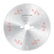 Circular saw blade with fine teeth, central arbor hole, red and white mechanical clamping indicators, and Freud branding.