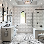 Matte black horizontal towel bar mounted on white subway tile wall in a bathroom setting.