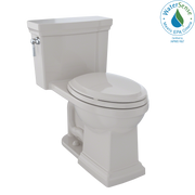 Beige one-piece elongated toilet with matching soft-close seat and tank with side lever handle.