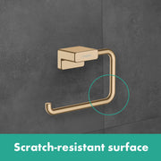 Matte black metal toilet paper holder with curved arm mounted on gray tile wall.