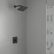 Matte black rectangular showerhead with perforations mounted on articulating arm, with matching square valve control on tile 
