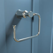 Polished nickel towel ring with curved rectangular shape mounted on blue wall.