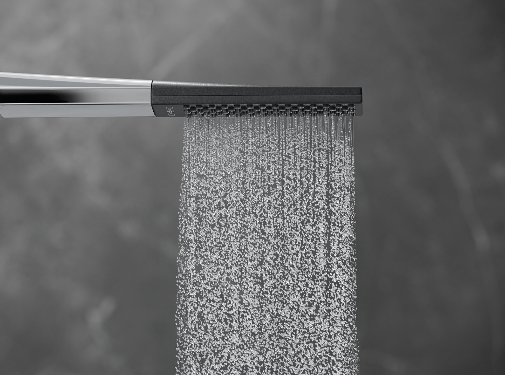Matte white rectangular handshower with chrome arm dispensing water in fine rain-like spray pattern.