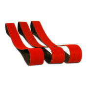 Three red sanding belts with black backing, one inch by thirty inches, arranged in a group.