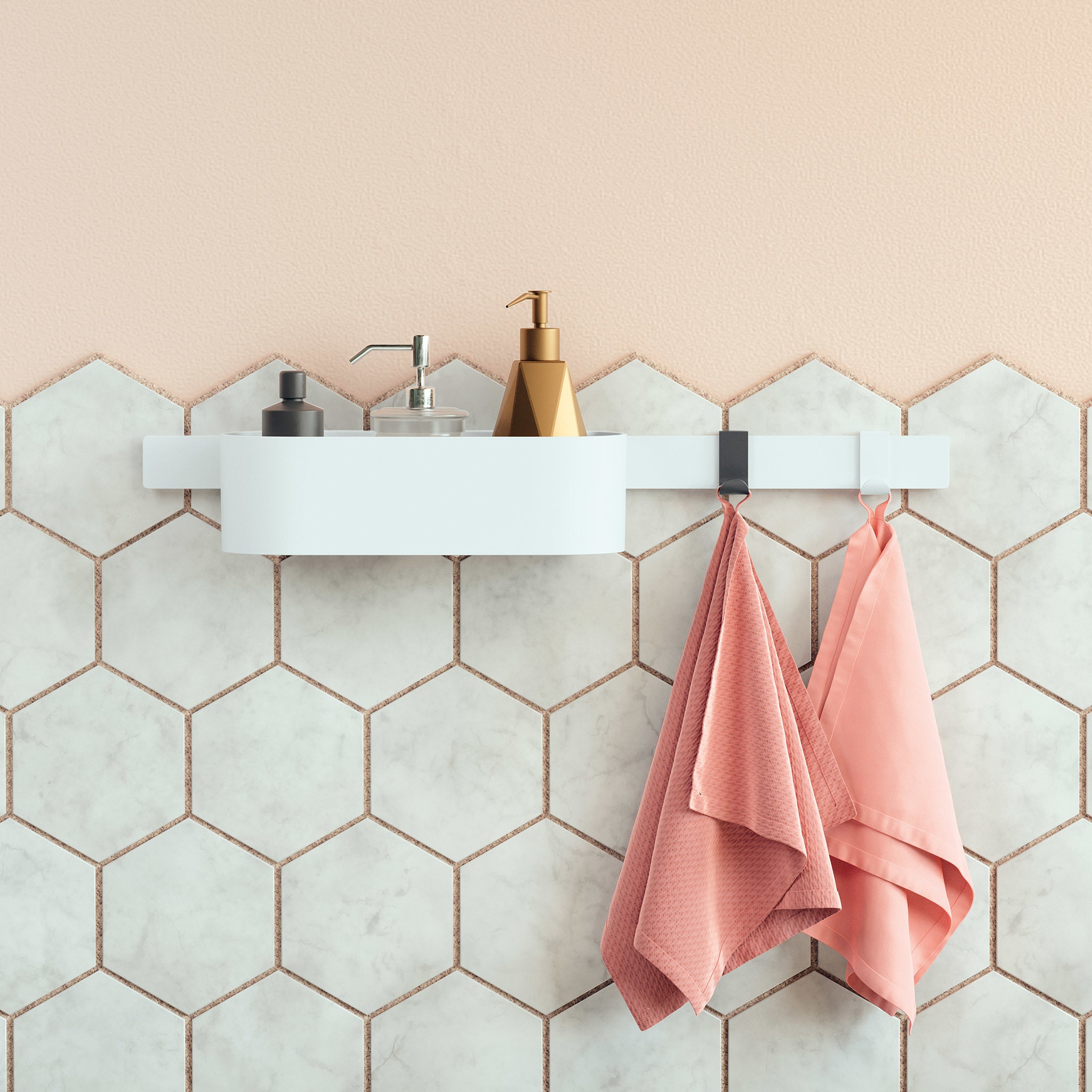 Matte white wide towel hook mounted on hexagonal tile wall with pink towels hanging from it.