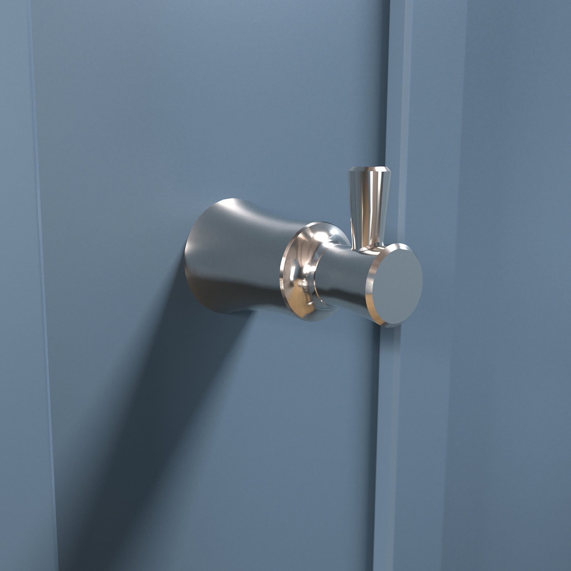 Polished nickel wall-mounted hook with cylindrical base and vertical post hook mounted on blue wall.
