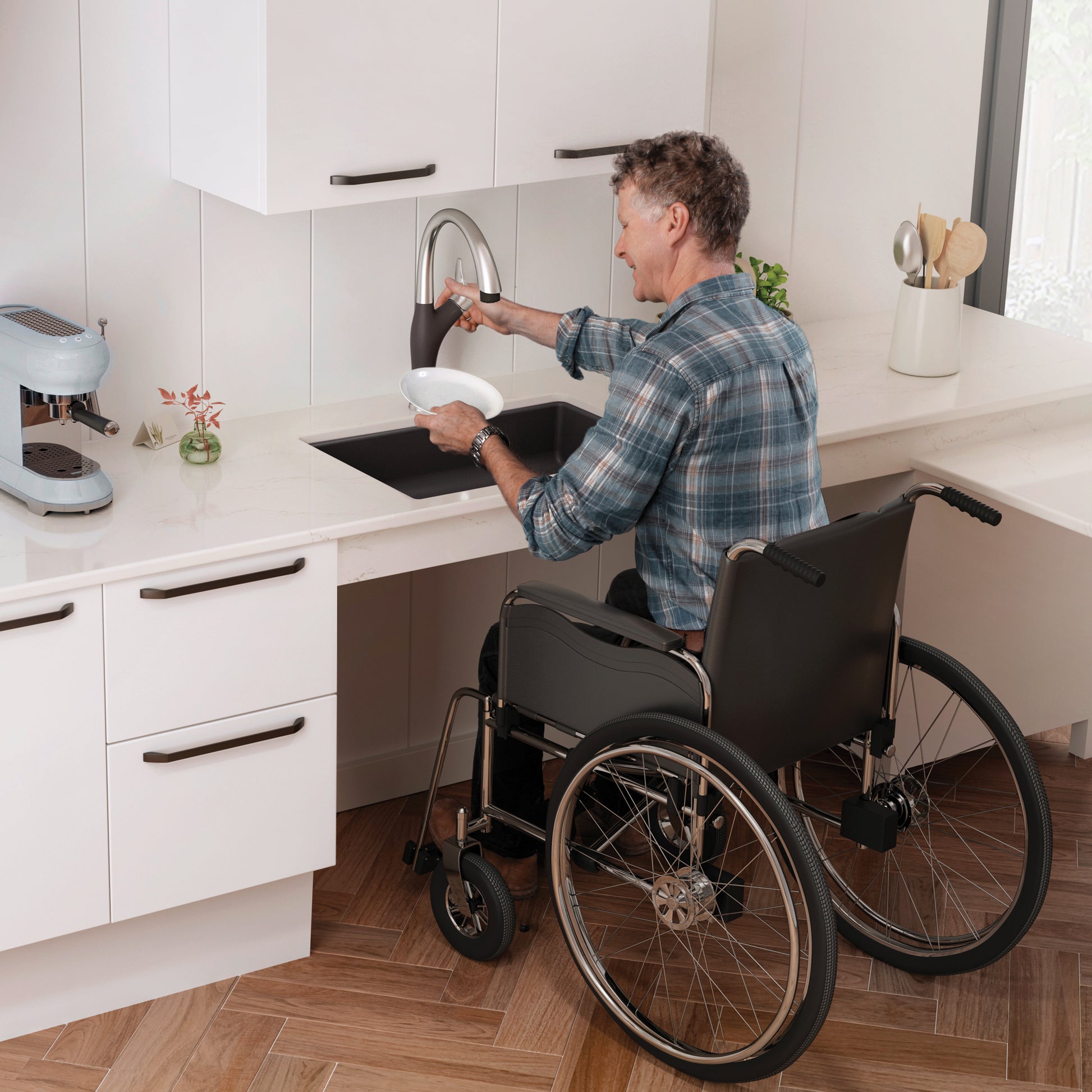 Black undermount kitchen sink with arc faucet installed under white cabinetry, shown in accessible height configuration.